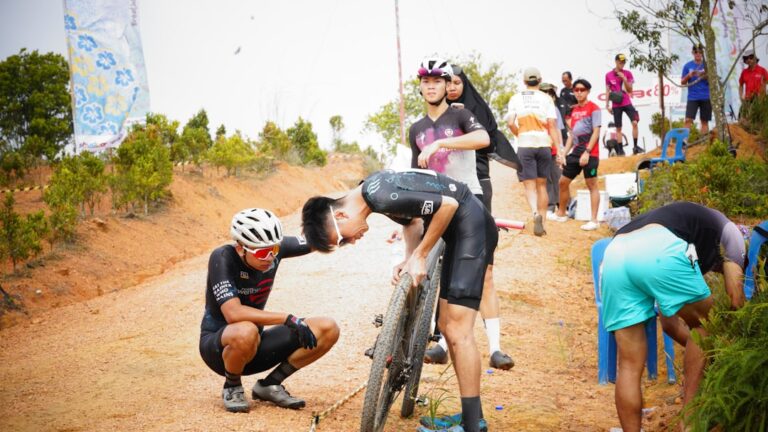 professional cyclist race day team mechanic preparation